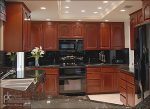 Kitchen remodel with cherry wood, liberty style upper doors, revere style doors on base cabinets.