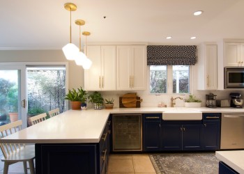 View 2 of Two-tone Refacing in Royal Blue and White Thermafoil, with Quartz countertops and Farmers Sink.