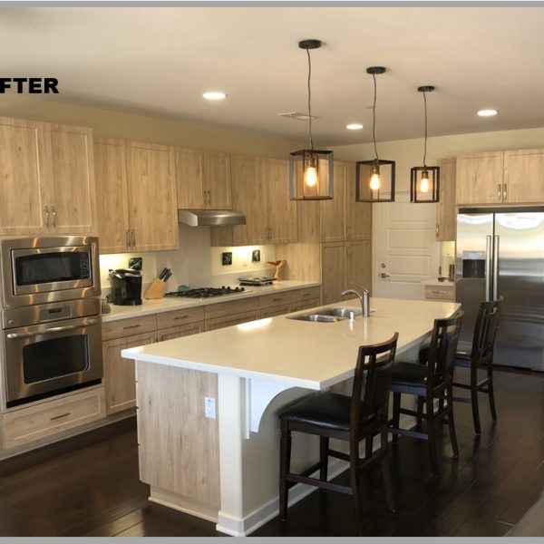 The same kitchen after refacing, with light woodgrain Thermofoil cabinets and the original layout unchanged
