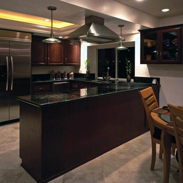 Kitchen before refacing, with dark cherry cabinets and black granite countertops