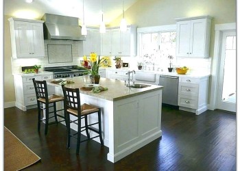 Customer wanted to lighten up a dark kitchen with white Thermafoil Refacing around their existing tan granite countertops.
